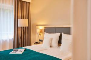 Rúm í herbergi á Best Western Premier Alsterkrug Hotel