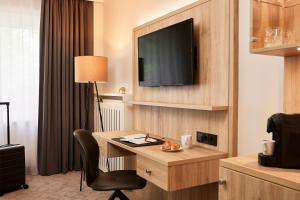 Sjónvarps- og/eða afþreyingartæki á Best Western Premier Alsterkrug Hotel