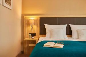 Rúm í herbergi á Best Western Premier Alsterkrug Hotel