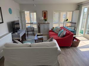 a living room with two couches and a table at The Coach House in Cirencester