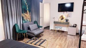 a hotel room with a bed and a chair and a desk at Le Sciantose Relais in Naples