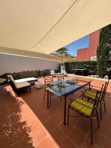 a patio with a table and chairs and a couch at Torremar Natura 532 in Vera