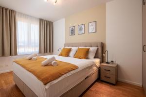 a bedroom with a large bed with two pillows on it at Split For You - 2BR Apartment with Free Garage Parking in Split