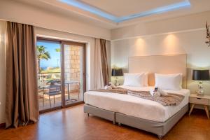 a bedroom with a large bed and a balcony at Bliss Villas Complex with private pool in Hersonissos +57 photos