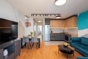 a kitchen and living room with a couch and a table at Split For You - 2BR Apartment with Free Garage Parking in Split +17 photos