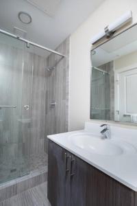a bathroom with a sink and a shower at 200mbps speeds Laundry Long Stays in Boston