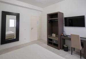 a living room with a tv and a mirror at Il Perugino Guest House in Rome
