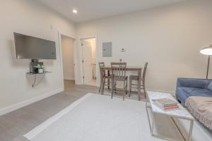 a living room with a blue couch and a table at Luxury at 2br 2ba 200mbps Internet in Boston