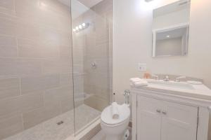 a bathroom with a shower and a toilet and a sink at Luxury at 2br 2ba 200mbps Internet in Boston