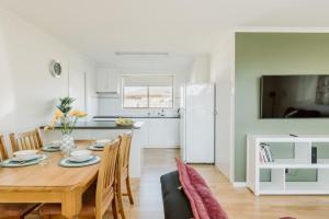 a kitchen and dining room with a table and chairs at The Seaside Spot in Devonport