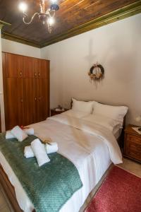 a bedroom with a large bed with two pillows on it at Atrapos in Karpenisi