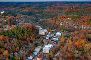 an aerial view of a town with autumn trees at 151 Spring Downtown Eureka Springs Suite B in Eureka Springs