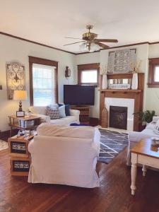 a living room with white furniture and a fireplace at Bungalow Bills Cozy and convenient to Rupp Arena UK Horse Park and Keeneland in Lexington