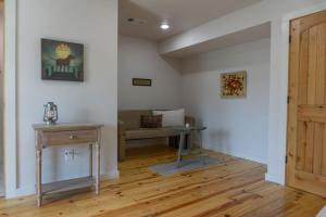 a living room with a table and a couch at Springs WishDowntown Historic Loop Downstairs King Free Parking in Eureka Springs +17 photos