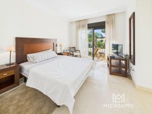 a bedroom with a large bed and a television at Two-Bedroom Townhouse in Roda Golf in Roda +13 photos