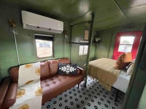 a small room with a bed and a couch in it at Midnight Train to Marfa 1948 Caboose in Marfa
