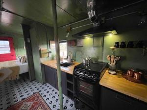 a small kitchen with a stove and a sink at Midnight Train to Marfa 1948 Caboose in Marfa