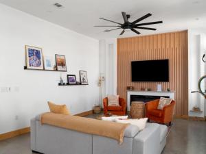 a living room with a couch and a flat screen tv at Welcome to the Milky Wayfarer in Marfa