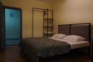 a bedroom with a bed and a door to a room at Hotel Alvida in Prizren