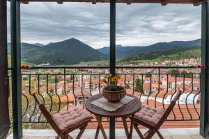 a table and chairs on a balcony with a view at Atrapos in Karpenisi