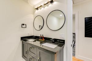 a bathroom with a sink and two mirrors on the wall at Spacious Deck Contemporary Home in Nashville! in Nashville +27 photos