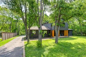 a house in the middle of a yard with trees at Spacious Deck Contemporary Home in Nashville! in Nashville
