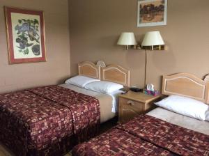 A bed or beds in a room at Lion Motel