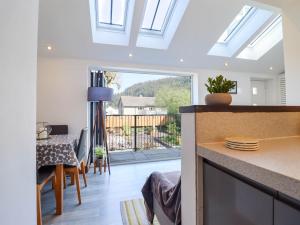 a kitchen and dining room with a view of a balcony at Dola in Betws-y-coed