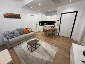 a living room with a couch and a table at Focolare Manzoni in Lecco