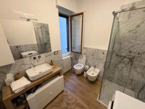 a bathroom with a toilet and a sink and a shower at Focolare Manzoni in Lecco