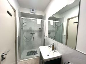 a bathroom with a shower and a sink and a mirror at Tigh Fitz Apartments - Inis Mór, Aran Island in Inis Mor +37 photos