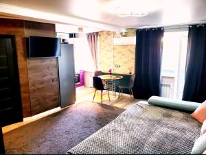 a living room with a couch and a table in a room at Stone city center ІІ in Kamianets-Podilskyi