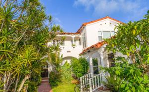 an exterior view of a white house with trees at 2BR Retreat Near Balboa Park in San Diego