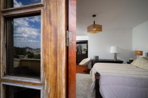 a bedroom with a view of a bed and a window at Casa Alto da Ribeira - Alojamento local in Póvoa de Lanhoso +13 photos