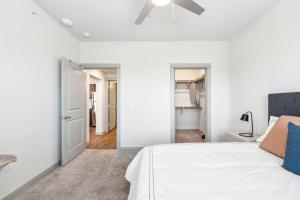 a bedroom with white walls and a bed with blue pillows at Chisholm Trace 1234 I Spacious 1 Bed 1 Bath in Cleburne +21 photos