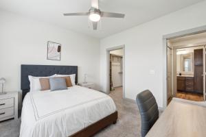 a white bedroom with a bed and a ceiling fan at Chisholm Trace 734 I Spacious 1 Bed 1 Bath in Cleburne +17 photos