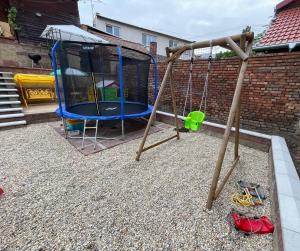 a swing set in a backyard with a playground at Apartmán Pohoda in Břeclav