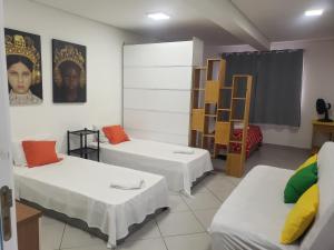 a room with two beds and a shelf at Ap super espaço próximo a 25 de março in Sao Paulo