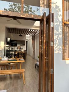 a kitchen and living room with a table and chairs at Cozy townhome in Krabi town in Ban Khlong Chi Lat