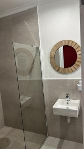 a bathroom with a sink and a mirror at Malaika Guest House in Cape Town +55 photos