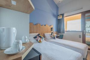 a hotel room with two beds and a table with plates on it at Sure Hotel by Best Western Mougins Belvedere in Mougins