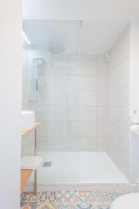 a bathroom with a shower with a glass door at Sure Hotel by Best Western Mougins Belvedere in Mougins