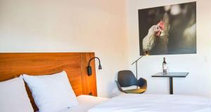 A bed or beds in a room at Hotel Dalgas, BW Signature Collection