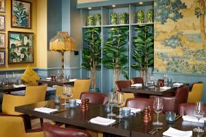 a restaurant with tables and chairs and a wall mural at The Kings Arms in Christchurch