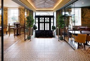 a restaurant with tables and chairs and a door at The Kings Arms in Christchurch