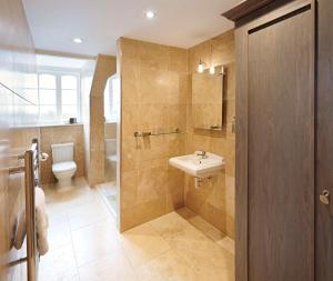 a bathroom with a sink and a toilet at The Kings Arms in Christchurch