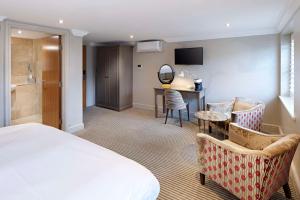 a hotel room with a bed and a desk at The Kings Arms in Christchurch