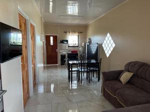 a living room with a couch and a table at Tulip Rosé appartments in Paramaribo