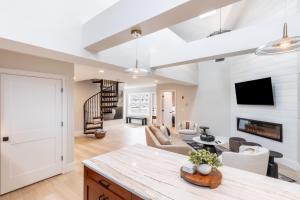 a kitchen and living room with a table and a living room at The Newport Lofts - 543 Thames Street in Newport