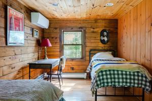 a bedroom with two beds and a desk and a window at PoolHot Tub Firepit Near Hikes Shops Dining Cragswood Lodge by AvantStay in New Paltz +92 photos